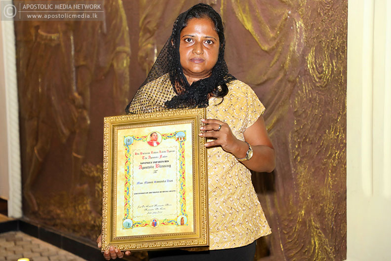 His Holiness The Apostle presents the Apostolic Blessing Certificate to Miss Manoji Dias